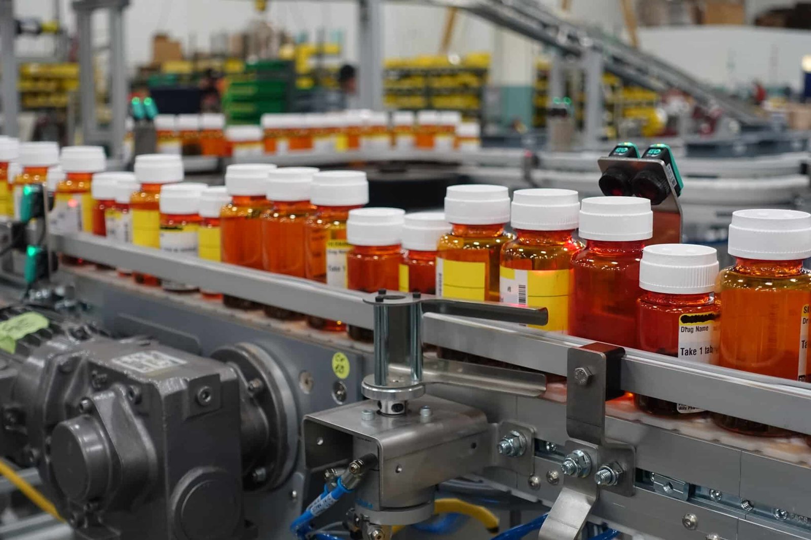 Pharmaceutical containers moving through an automated production line