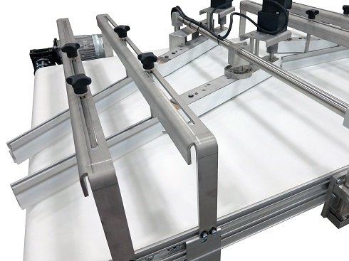 Angled powered top conveyor used for product spacing