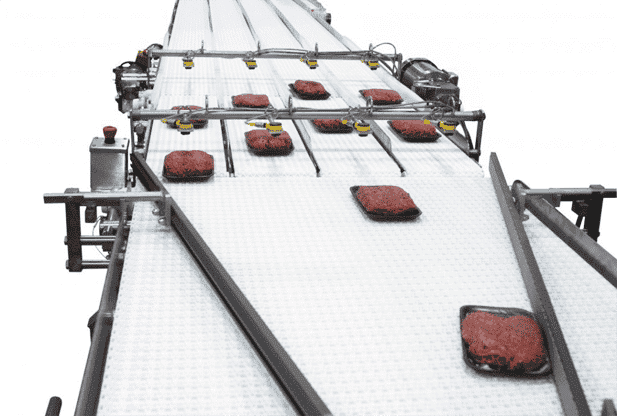 Curved conveyor merging two product flow paths