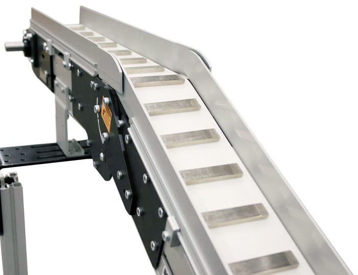 Magnetic conveyor holding a metal part during transport
