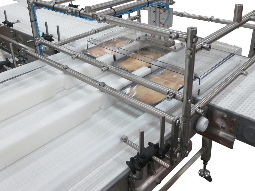 Sanitary conveyor mechanism flipping packaged products