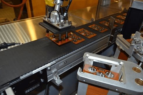 Indexing conveyor system for production flow