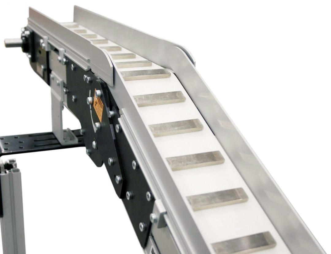 Magnetic belt conveyor carrying ferrous parts along a production line