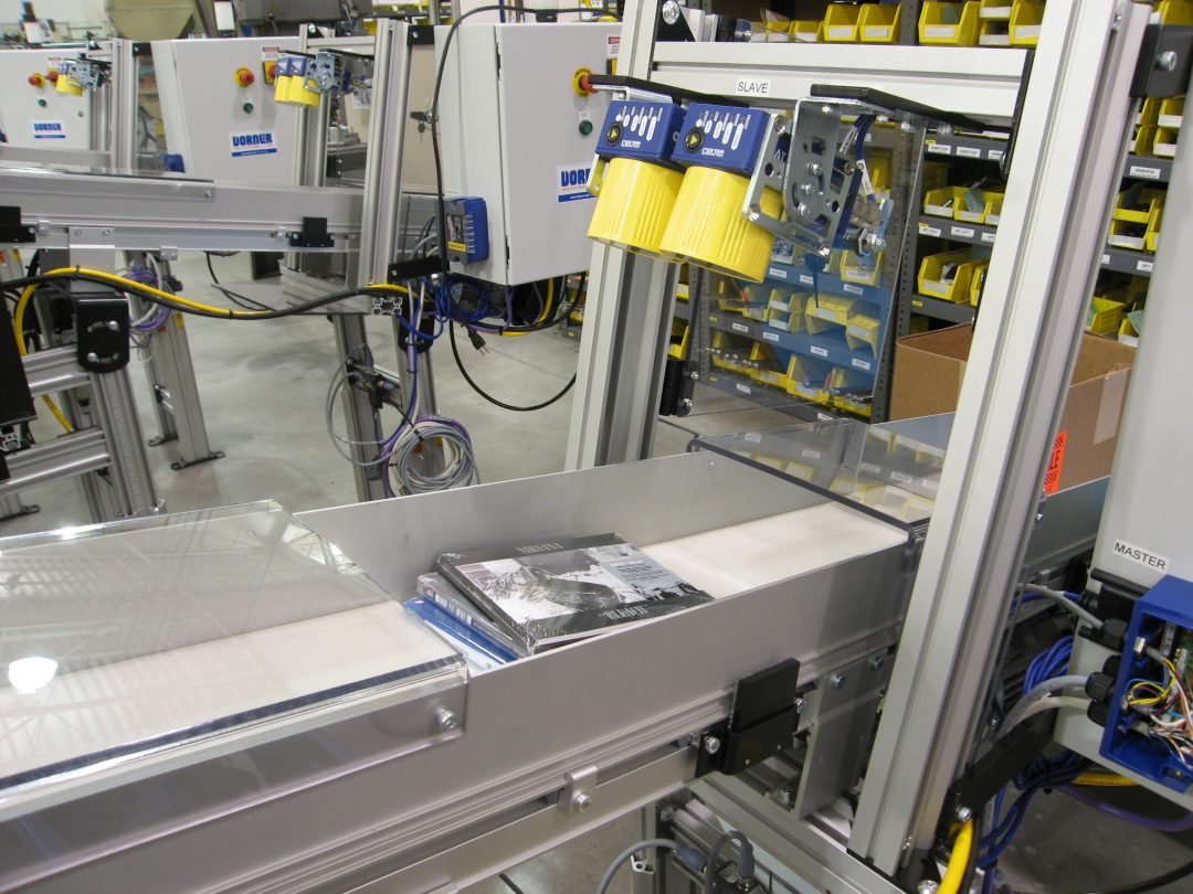 Product pusher mounted beside a conveyor line
