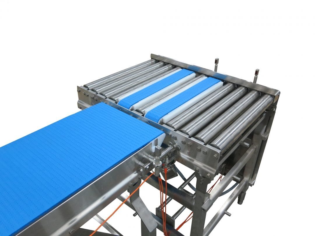 Detail of a pop-up transfer mechanism between conveyor sections