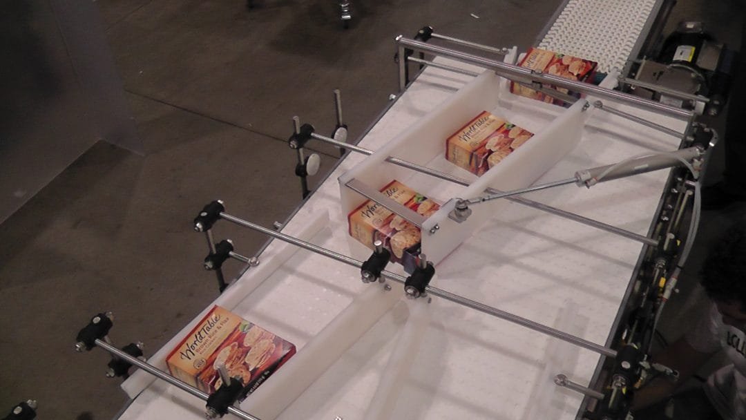 Guided conveyor diverting boxed product into lanes
