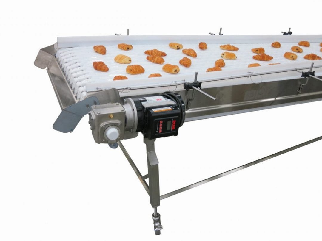 Bakery product moving across a wide belt conveyor