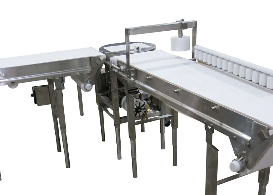 Cheese turner with weigh station and bump turn