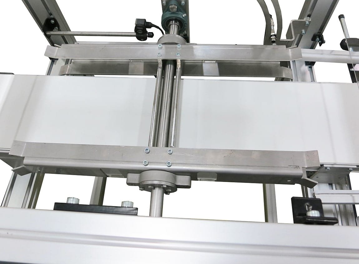 Conveyor product flipper rotating items during processing